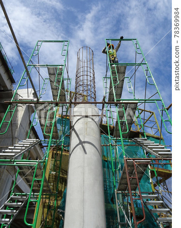 SEREMBAN, MALAYSIA -AUGUST 1, 2020: The concrete pillar structure is under construction at the construction site. The mold uses timber formwork and is temporarily supported with scaffolding. SEREMBAN, MALAYSIA -AUGUST 1, 2020: The concrete pillar structure is under construction at the construction site. The mold uses timber formwork and is temporarily supported with scaffolding. 78369984