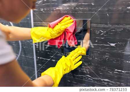 Bathroom cleaning, woman in gloves with rag polishing tiles and chrome accessories Bathroom cleaning, woman in gloves with rag polishing tiles and chrome accessories 78371233