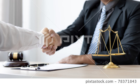 Businessman shaking hands with a lawyer or judge After signing the contract and the agreement is complete, Approval of an agreement between business and law, End of the legal case. Businessman shaking hands with a lawyer or judge After signing the contract and the agreement is complete, Approval of an agreement between business and law, End of the legal case. 78371843