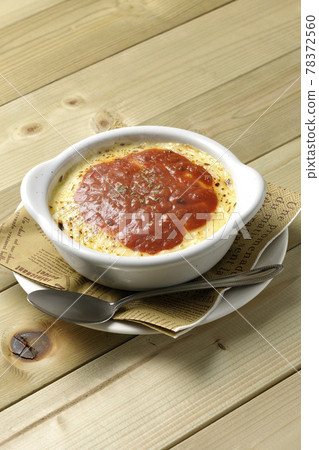 熱多利亞、烤麵包和銀勺,在餐巾紙上放上大量融化的棕色奶酪 熱多利亞、烤麵包和銀勺,在餐巾紙上放上大量融化的棕色奶酪 78372560