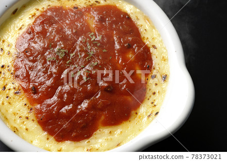 Doria and gratin with plenty of melted and browned cheese taken on a black background (overhead view) Doria and gratin with plenty of melted and browned cheese taken on a black background (overhead view) 78373021