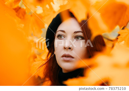 Autumn romantic portrait of a red-haired woman. 78375210