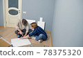 couple man and woman together install furniture in their apartment. 78375320