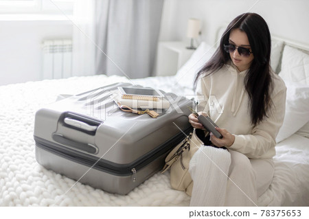 Trendy woman counting checking money cash dollar in wallet before leaving bedroom ready to travel 78375653