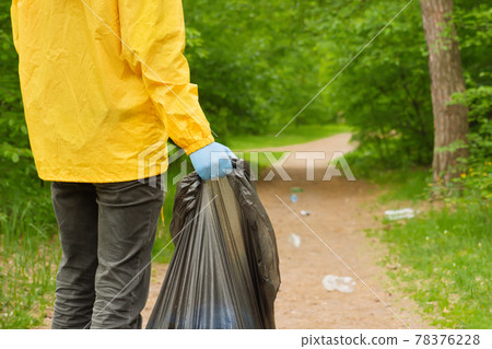Volunteer clean up trash a park background. Ecology pollution plastic. Eco friendly environment. Protect nature save environment. Concept environmental care. People volunteer collect garbage in forest 78376228