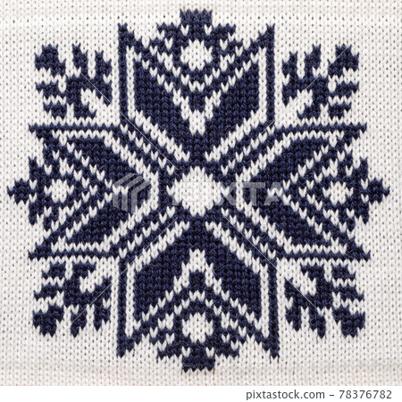 Blue knitted snowflake ornament on Christmas sweater 78376782
