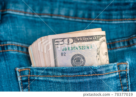 Dollars in jeans.Macro shot of trendy jeans with US dollar bills in a pocket. Financial concept. Dollars in jeans.Macro shot of trendy jeans with US dollar bills in a pocket. Financial concept. 78377019
