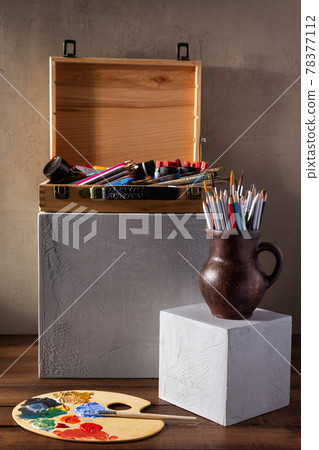 Painter tools and tubes on table background texture. Paintbrush and palette as art still life Painter tools and tubes on table background texture. Paintbrush and palette as art still life 78377112