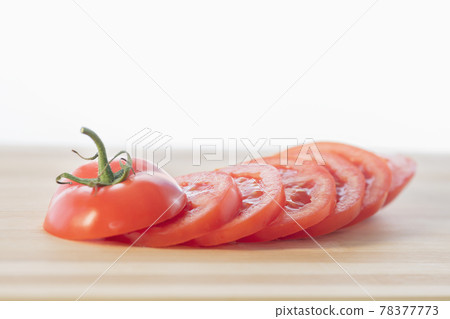 Red tomato slices on cutting board isolated on white backgroung: Selective focus. Healthy food concept 78377773