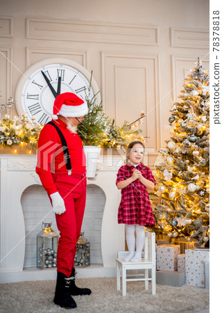 Santa Claus and child at home against Christmas tree. Family holiday concept Santa Claus and child at home against Christmas tree. Family holiday concept 78378818