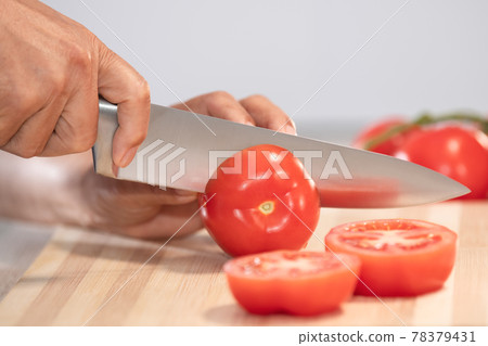 Woman cutting fresh tomato: Selective focus. Diet and healthy food concept 78379431