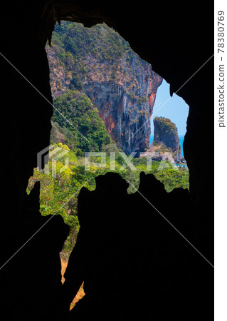 Overlooking the jungle from the opening of a limestone cave (Batcave, Railay, Krabi Province, Kingdom of Thailand) 78380769