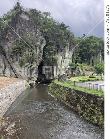 A stream flowing by the rough stone wall A stream flowing by the rough stone wall 78381275