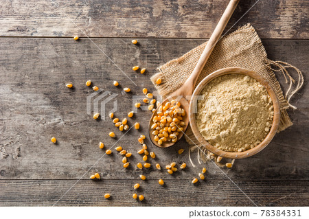 Corn flour in bowl on wood 78384331
