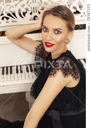 young pretty lady in black lace fashion style dress posing in rich interior of royal hotel room, luxury lifestyle people concept young pretty lady in black lace fashion style dress posing in rich interior of royal hotel room, luxury lifestyle people concept 78387353