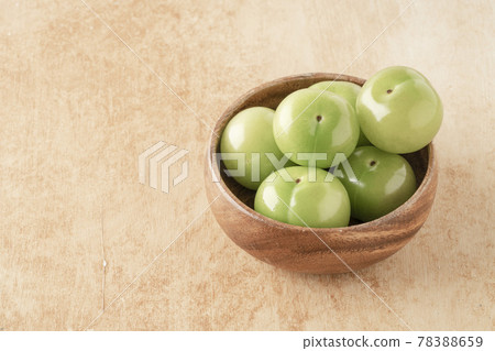 fresh green plum fruits in a bowl on table 78388659
