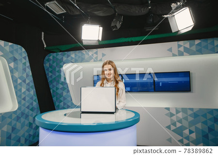 Young pretty tv presenter in studio before broadcasting Young pretty tv presenter in studio before broadcasting 78389862