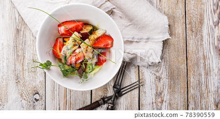 Food banner. Delicious summer salad. Salad with fresh strawberries, baked beets, yellow tomatoes, dor blue cheese and herbs in a white bowl on a light rustic background. Summerfood. Copy space Food banner. Delicious summer salad. Salad with fresh strawberries, baked beets, yellow tomatoes, dor blue cheese and herbs in a white bowl on a light rustic background. Summerfood. Copy space 78390559