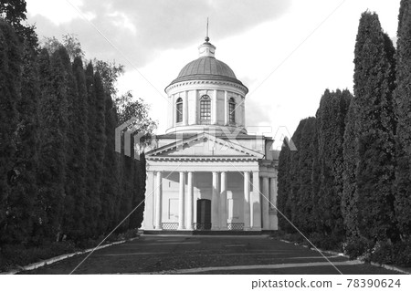 All Saints church in Nizhyn, Chernihivska oblast, Ukraine. Beautiful old building XVIII century with dome for religious purposes, Orthodox Church. Ukrainian baroque architecture. Shady alley. Scenery. 78390624