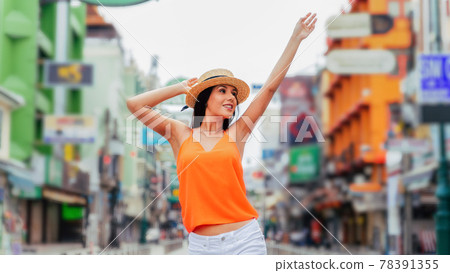 Young brunette woman traveling with attractive toothy smile in urban street. Young brunette woman traveling with attractive toothy smile in urban street. 78391355