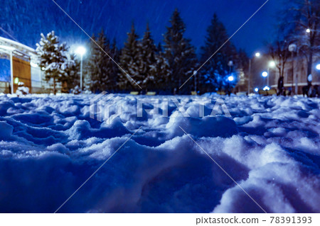 Night winter landscape. Snow drifts in the light of a lantern. Blue background 78391393