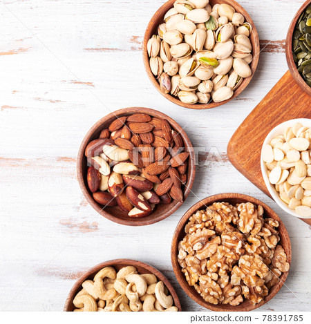 Different kind of nuts in wooden bowls 78391785