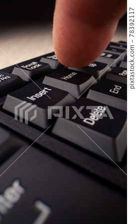 Person hand presses home button among control keys Person hand presses home button among control keys 78392117