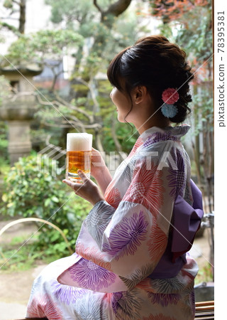 A woman in a yukata drinking beer on the porch A woman in a yukata drinking beer on the porch 78395381