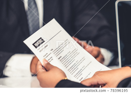 Human resources department manager reads CV resume 78396195