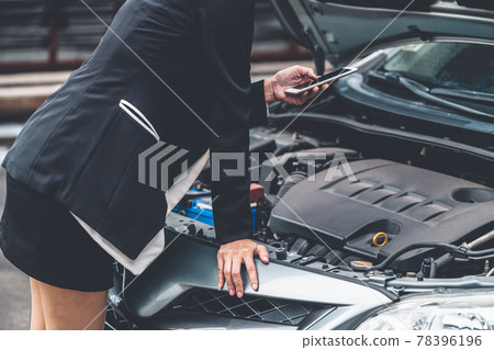 Woman whose car breakdown call for repair service. 78396196