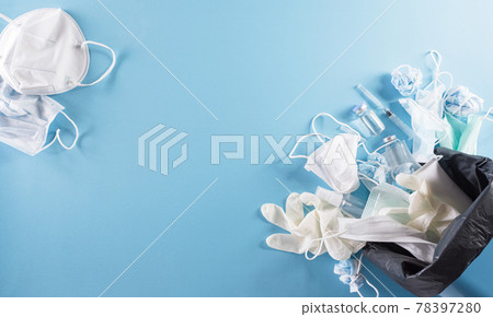 Covid-19 plastic waste and garbage, disposable masks, medicl glove, alcohol gel bottle and needle in trash bin. Pile of used personal protective equipment PPE. Pollution by surgical masks during the Covid-19 plastic waste and garbage, disposable masks, medicl glove, alcohol gel bottle and needle in trash bin. Pile of used personal protective equipment PPE. Pollution by surgical masks during the 78397280