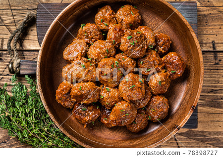 Baked Meatballs in tomato sauce from minced beef and pork meat with thyme in rustic wooden plate. background. Top view 78398727