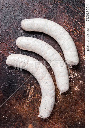 Raw German white sausage weisswurst on kitchen table. Dark background. Top view 78398924