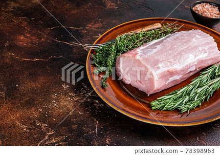 Fresh Raw pork loin meat with thyme and rosemary on rustic plate. Dark background. Top view. Copy space Fresh Raw pork loin meat with thyme and rosemary on rustic plate. Dark background. Top view. Copy space 78398963