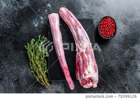 Fresh Raw whole Beef veal Oxtail Meat on marble board with herbs. Black background. Top view Fresh Raw whole Beef veal Oxtail Meat on marble board with herbs. Black background. Top view 78399126