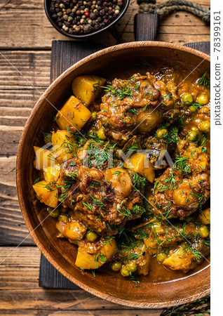 Lamb oxtails tails stew with vegetables in a wooden plate. wooden background. Top view 78399161