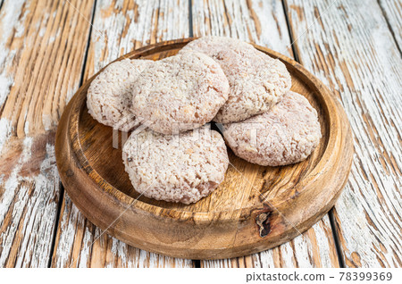 Raw chicken patty cutlet with breadcrumbs. White wooden background. Top view Raw chicken patty cutlet with breadcrumbs. White wooden background. Top view 78399369