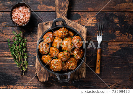 Meatballs in tomato sauce from beef and pork meat with thyme in rustic pan. Dark background. Top view 78399453