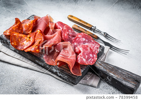 Assorted meat appetizers - salami, jamon, choriso sausages. White background. Top view 78399458