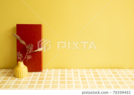 Notebook and vase of dry flowers on beige ceramic mosaic tile desk. yellow wall background. Work and study place Notebook and vase of dry flowers on beige ceramic mosaic tile desk. yellow wall background. Work and study place 78399481
