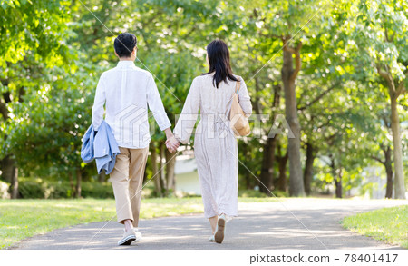 Middle couple walking hand in hand 78401417