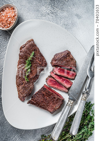 Roasted sliced rump beef meat steak on a plate with thyme. White background. Top view Roasted sliced rump beef meat steak on a plate with thyme. White background. Top view 78401633