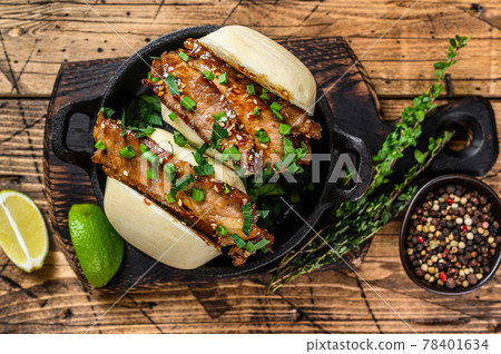Bao bun, steamed sandwich with pork. Wooden background. Top view 78401634