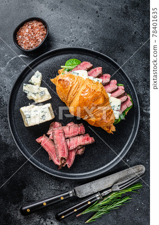 Sandwich with Fillet Mignon meat steak, Croissant and blue cheese. Black background. Top view Sandwich with Fillet Mignon meat steak, Croissant and blue cheese. Black background. Top view 78401635