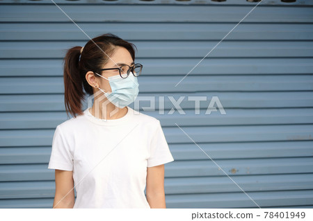 Woman wearing medical face mask, prevent coronavirus or Corona Virus Disease (Covid-19). Health concept Woman wearing medical face mask, prevent coronavirus or Corona Virus Disease (Covid-19). Health concept 78401949