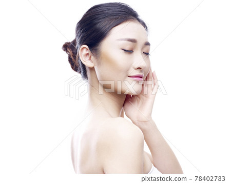 studio portrait of a young asian woman, hand on chin, eyes closed, side view, isolated on white 78402783