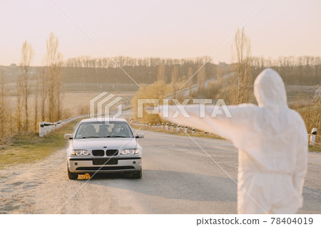 Person in a protective suit checks the temperature Person in a protective suit checks the temperature 78404019