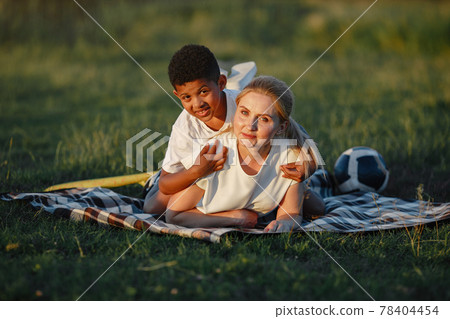 Multi-racial family playing in a summer park Multi-racial family playing in a summer park 78404454