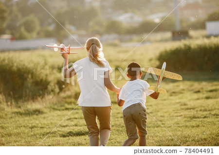 Multi-racial family playing in a summer park 78404491