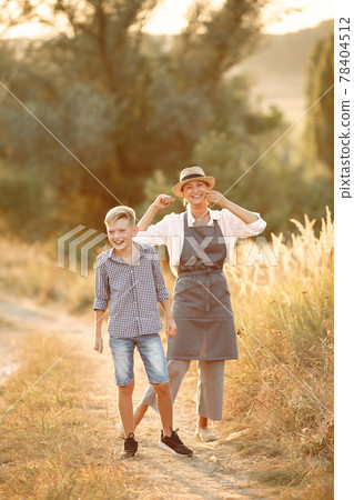 Two mothers with young son walking in a spring field 78404512